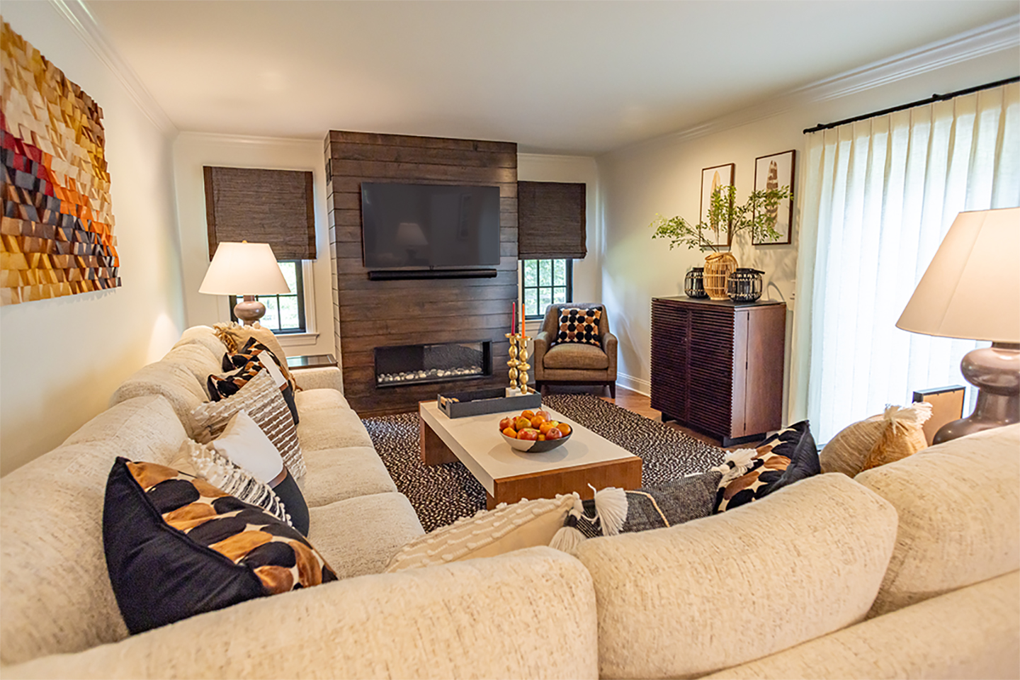 AFTER: This transformative renovation has breathed new life into this family room emerging as a haven of comfort and relaxation. The new focal point, the fireplace, increases the “cozy” level of the room, bathing the room with the warmth of the fire.